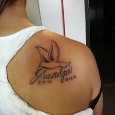 a woman with a tattoo on her shoulder that reads grandpa and has a dove in it