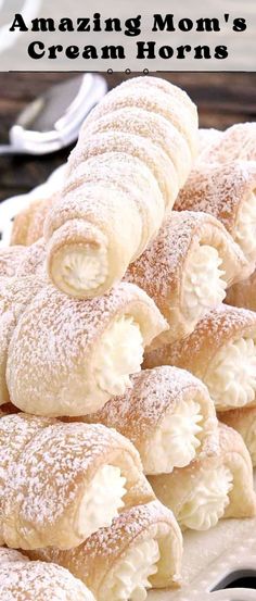 a pile of powdered sugar filled pastries sitting on top of a white plate