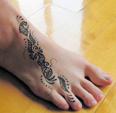 a woman's foot with an intricate design on it