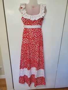 "Amazing vintage dress from the 70's! Has two designer labels.  Princess Kaiulani Hawaii and Carol & Mary Hawaii. Red floral cotton fabric. Bust has a white cotton lining. Maxi length. Floral lace accents, ruffles around collar. Sleeveless. Zips in back with eye hook. Comes with a white ribbon, I do not believe this is the original sash, but it works or you can find your own (loops attached).  Pockets. In Excellent Vintage Condition with no visible flaws! Size on tag 10. Measurements: Bust: 36\" White Lined Cotton Vintage Dress, White Cotton Lined Vintage Dress, White Cotton Vintage Dress With Lining, 1970s Cotton Vintage Dress For Daywear, Red Sleeveless Vintage Maxi Dress, White Cotton Lined Maxi Dress, Red Cotton Vintage Summer Dress, 1970s Red Summer Dresses, 1970s Style White Maxi Dress