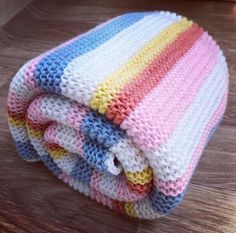 three crocheted blankets stacked on top of each other