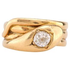 Center Stone: Old Mine Cut Diamond Weight: Approximately .70 Carat Color: J Clarity: SI Metal: 18K Yellow Gold Era: Victorian Circa: 1904's Hallmarks: Birmingham Hallmarks Size: 9.75 and can be resized Gram weight: 8.25 This enchanting Victorian snake ring, crafted in 18K yellow gold, features a captivating .70 carat old mine cut diamond at its center. The diamond, graded J in color and SI in clarity, is beautifully set within the coiled serpent design, a symbol of eternal love and wisdom during the Victorian era. Hallmarked with Birmingham marks and weighing 8.25 grams, this ring from the early 1900s exudes both charm and vintage elegance. Sized at 9.75, it can be resized to fit, making it a stunning and meaningful addition to any fine jewelry collection. Yellow Gold Vvs Clarity Snake Ring For Anniversary, Formal Yellow Gold Snake Ring With Single Cut Diamonds, Antique Cocktail Ring, Victorian Diamond Ring, Unique Rings Vintage, Old Mine Cut Diamond, Diamond Engagement Rings Vintage, Victorian Rings, Snake Ring