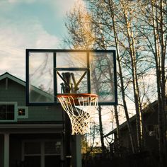 an outdoor basketball hoop in front of a house