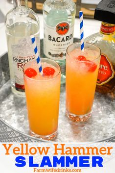 two glasses filled with orange juice and garnished with strawberries