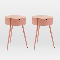 two pink side tables with wooden legs