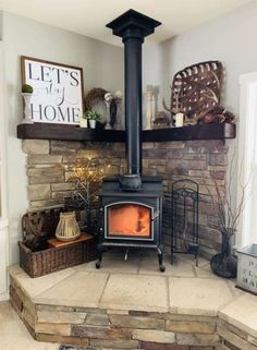 a wood burning stove sitting on top of a stone floor