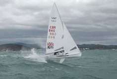 a sailboat in the ocean on a cloudy day