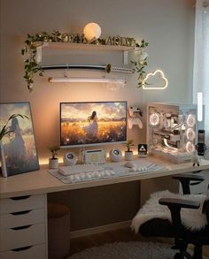 a desk with a computer on top of it next to a window and some plants