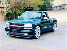 a green truck parked in a parking lot