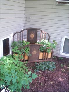 an old iron bed with plants growing out of it