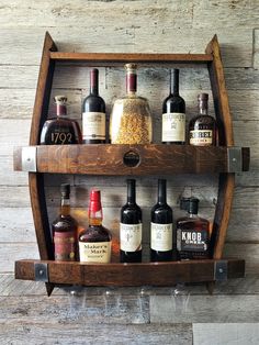 a wooden shelf filled with bottles of liquor