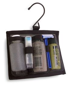 an open travel pouch with two bottles and a toothbrush in it on a white background