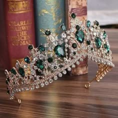 a green tiara sitting on top of a wooden table next to books and a bookcase