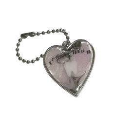 a heart shaped keychain with an image of a baby on it's back