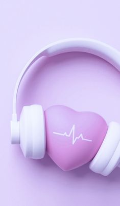 a pink heart - shaped object with white headphones attached to it