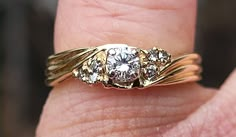 Fresh estate find this spectacular 1980s 1990s era vintage 14k yellow gold rare highly detailed ribbed sides style ladies engagement ring with stunning genuine diamonds. This ring is striking with intricate gold work with one round brilliant cut genuine diamond measuring 3.53 mm in diameter(Approx 17 pt) sparkly diamond. There is also 3 small round diamonds on each side of the center large diamond. Diamonds have tons of sparkle and life. Fully stamped with 14k purity mark nicely legible and weig Masculine Diamond Ring, 2000s Engagement Ring, 1980s Engagement Ring, Vintage Yellow Gold Engagement Ring, 80s Engagement Ring, Vintage Gold Rings, Vintage Jewellery Rings, Best Engagement Rings, Dream Engagement Rings