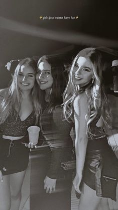 three beautiful young women standing next to each other