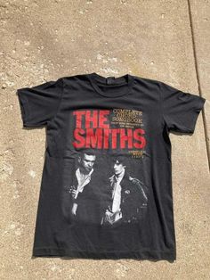 The Smiths Vintage Retro Design T-shirt, Vintage The smiths t-shirt, The Smiths Retro Music Band Tee, The Smiths band t-shirt gift for fan  NOTE ABOUT SHIPPING & CUSTOMS I use local printers in United States, Canada, UK, Australia. Germany & Italy. This ensures that you will never be charged with surprise customs fees on your tee. . All t-shirts are custom made to order and are printed using the latest ink to garment technology, a technology superior to heat transfer or screen print. - Heather colors are 52% combed and ring-spun cotton, 48% polyester - Athletic and Black Heather are 90% combed and ring-spun cotton, 10% polyester - Solid Colors 100% pre-shrunk cotton - Fiber content may vary by color FOR THE BEST FIT; (See Size Chart in Images). 1) Lay a t-shirt on a flat surface. 2) Measur The Smiths Merch, The Smiths Band, Band Merch Ideas, The Smiths T Shirt, Vintage Band T Shirts, Vintage Band Tees, The Smiths, Band T Shirts, Music Band