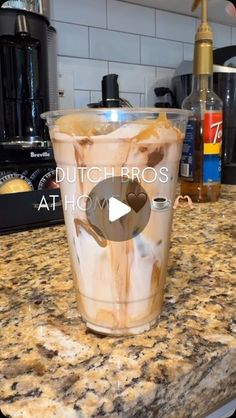 a cup filled with liquid sitting on top of a counter