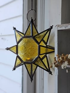 a stained glass star hanging from the side of a door