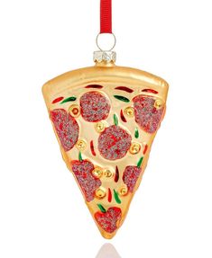 a christmas ornament with a slice of pizza hanging from it's side