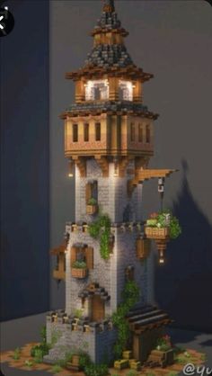 a tall tower with lots of windows and plants on the top of it's sides