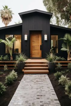 a black house with steps leading to the front door