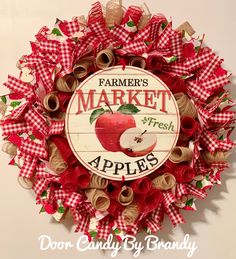 a red and white wreath with an apple on it that says farmer's market apples