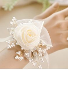 a close up of a person's arm wearing a bracelet with flowers on it