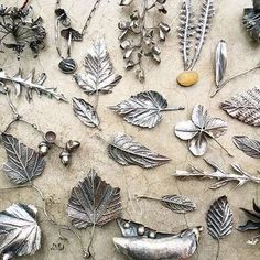 many different metal items are laying on the ground together, including leaves and acorns