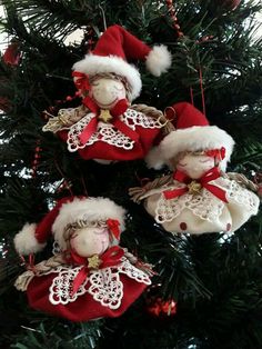 three christmas ornaments hanging from a tree with red and white decorations on it's branches