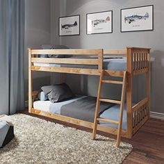 a wooden bunk bed sitting on top of a hard wood floor next to a window