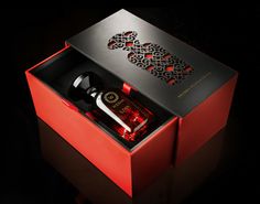 an open red box containing a bottle of booze