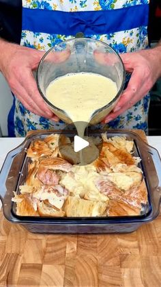 a person pours sauce into a casserole dish with croissants