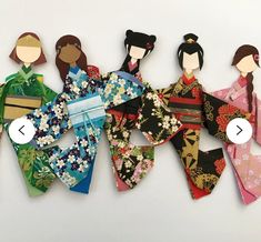 an assortment of paper dolls are arranged on a white surface, with one being cut out and the other is made from fabric