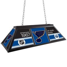 Illuminate your game room, garage, or pool table with the officially licensed St. Louis Blues Patch Lights by Trademark Gameroom. This premium light fixture looks great on or off with officially licensed logos and artwork on all four sides of the lamp shade. The room light features a durable powder-coated metal frame, 3/16-inch-thick light defusing acrylic panels, and a 12-foot-long three-prong cord for versatile hanging options. Electric Blue Pool Table Felt, Pool Table Clover The Home Depot, Stained Glass Pool Table Light, Game Room Lighting, Man Cave Accessories, Novelty Lamps, St Louis Union Station Aquarium, Pool Table Lighting, St Louis Blues