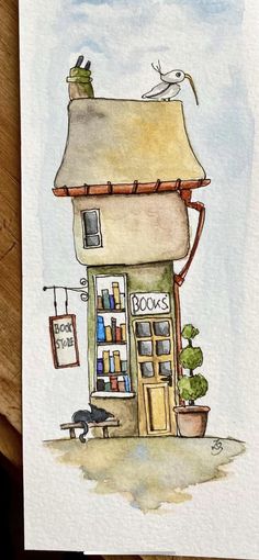 a drawing of a book store with a cat sitting on top of it and a bird perched on the roof