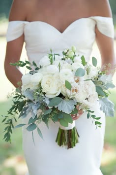 a woman holding a bouquet of flowers on her wedding day in front of an instagram page