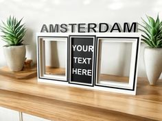 there are two frames on the shelf with plants in them and an amsterdam sign above it