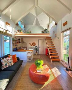 a living room filled with furniture and lots of windows