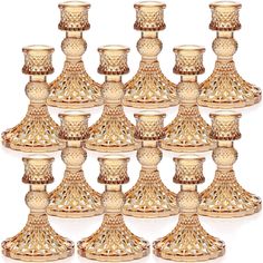 a set of twelve gold plated candlesticks with filigreen designs