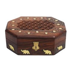 an intricately carved wooden box with elephants and hearts inlaying the top, on a white background