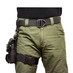 a man in green pants holding a black belted holster on his right side, with the back pocket open