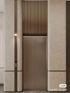 an elevator in a building with marble walls and flooring that has vertical blinds on the doors