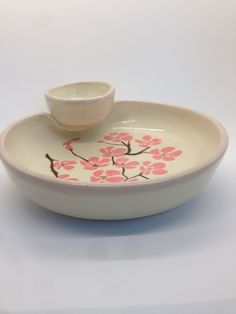 a white bowl with pink flowers on it