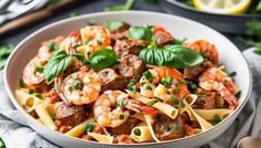 a white bowl filled with pasta and shrimp