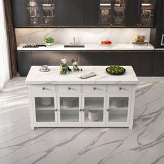 a kitchen with marble counter tops and white cabinets