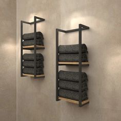 there are two shelves with towels on them in the bathroom, one is black and the other is gray