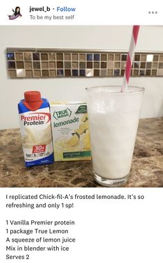 a glass of milk next to a carton of ice cream on a counter top