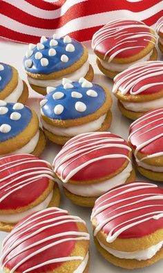 red, white and blue decorated cookies are on a plate next to an american flag